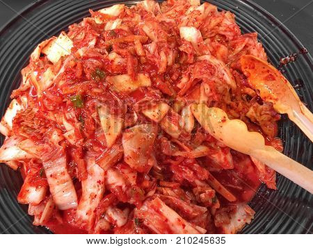 fresh spicy cabbage Kimji on black dish