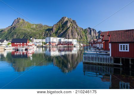 Henningsvaer Norway - August 19 2017: Picturesque fishing port in Henningsvaer on Lofoten islands Norway with typical red wooden buildings and small fishing boats
