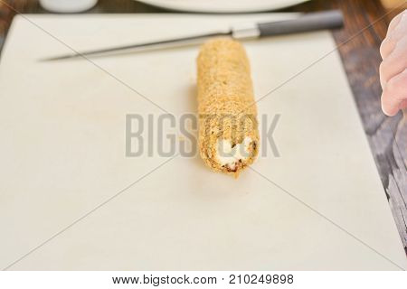 Roll unagi furay on cutting board. Long japanese sushi roll on white cutting board. Traditional japanese food.