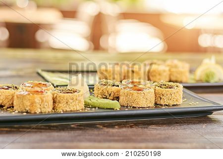 Set of unagi sushi rolls, blurred background. Sushi roll in restaurant. Traditional japanese food.