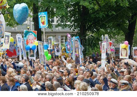 STOCKHOLM SWEDEN - JUN 13 2017: Family and friends to the graduating students waiting outside school with funny posters at the dance school BalettakademienJune 13 2017StockholmSweden