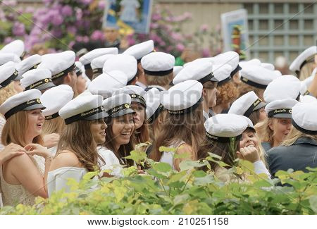 STOCKHOLM SWEDEN - JUN 13 2017: Smiling swedish students wearing white graduation caps after graduation at the dance school Balettakademien June 13 2017StockholmSweden