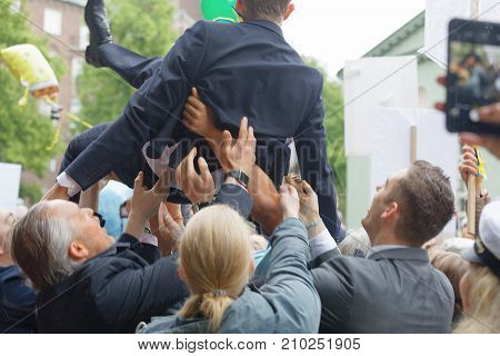 Stockholm Sweden - Jun 13 2017: Family Throwing Graduating Student In The Air To Celebrate At The Da