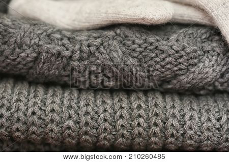 Knitted details of warm clothes sweater and gloves