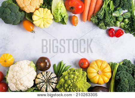 Healthy eating, top view of colorful rainbow vegetables on the light grey background, copy space for text in the middle, selective focus