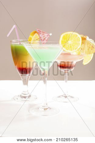 Tropical fruit cocktail concept. Cocktail with umbrella colorful illustration on isolated white studio background. Sexy delicious fashion drinks. Alcohol cocktails.