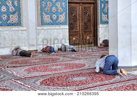 Fars Province Shiraz Iran - 19 april 2017: Shah Cheragh Shrine Iranian parishioners rest and pray in the courtyard of the mosque.