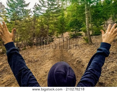 Hands and arms outstretched in enjoyment of nature
