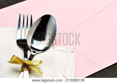 Silver Spoon And White Napkin On Pink With Gray Background