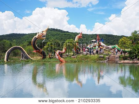 BANGKOK THAILAND - OCTOBER 08 2017: King of Naga statues group in the pond over mountain and blue sky background at Buddha Uttayarn Luang Phu Sod in Ban Na Dam Prachin Buri province Thailand.