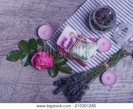 Handmade Soap with bath and spa accessories. Dried lavender, oregano and nostalgic pink rose. Spa background