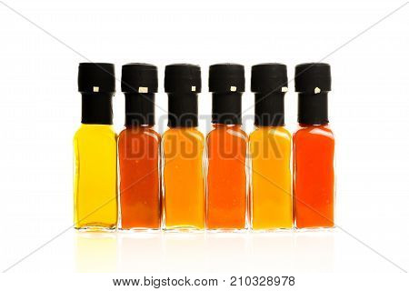 Set Of Hot Chili Sauce Glass Bottles On White Background.