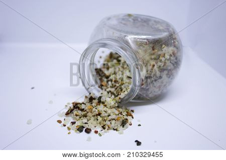 Spilled coarce sea salt with different spices