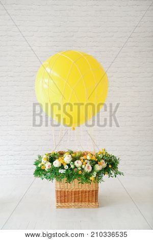 decor for the holiday birthday. balloon with a basket decorated with fresh flowers