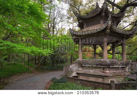 Traditional Chinese gazebo on the coast of West Lake, popular public park in Hangzhou city, China.