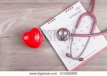 Check Heart Concept : Woman Hands Holding Red Heart And Stethoscope On Brown Wooden Table