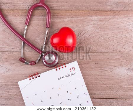 Check Heart Concept : Red Heart, Calendar And Stethoscope On Brown Wooden Table Background