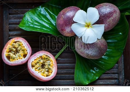 Passion fruit whole and slise on a natural background. Tropical fruits. The Fruit of Passion. Maracuya