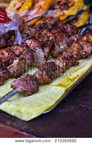 closeup of some meat skewers being grilled in a barbecue
