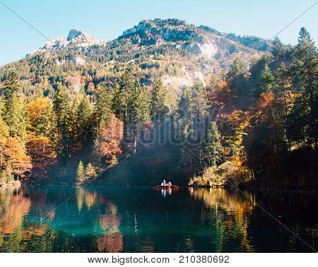 Autumn time at romantic forest lake Blausee, one of the best known mountain lakes in Switzerland.