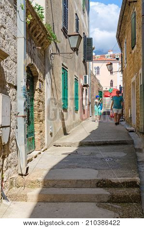 HERCEG NOVI MONTENEGRO - SEPTEMBER 10 2017: Unknown tourists walk along narrow street in Old Town Herceg Novi Montenegro