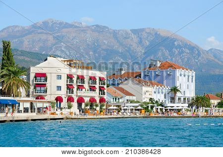 TIVAT MONTENEGRO - SEPTEMBER 10 2017: Unknown tourists rest on beach of beautiful promenade of popular resort town of Tivat Montenegro