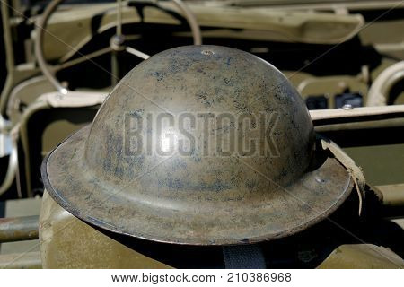 a british helmet of World War II on the jeep