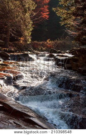 Autumn view of the Mumlava River. Krkonose National Park in the Czech Republic. Waterfall on the river