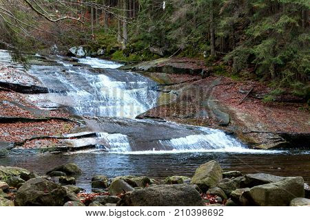 Autumn view of the Mumlava River. Krkonose National Park in the Czech Republic. Waterfall on the river