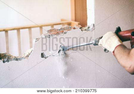 Construction worker using pneumatic hammer construction site concept.