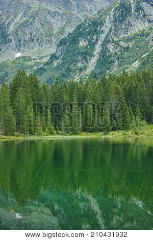 Small Forest Lake In Alpen Mountains, Place For Relaxation And Tranquil Vacation