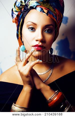 beauty bright real african woman with creative make up, shawl on head like cubian closeup smiling