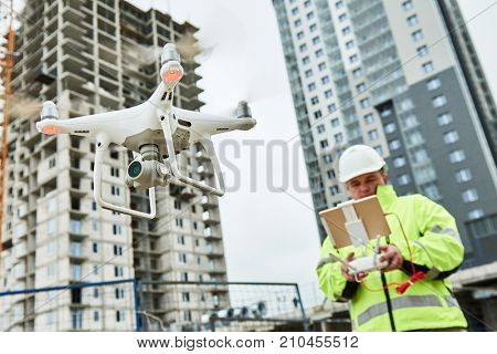 Drone operated by construction worker on building site
