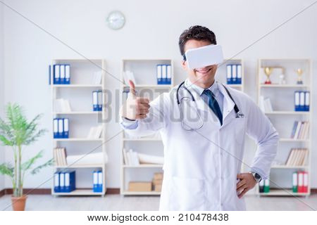 Young doctor with vr virtual reality headset working in the offi