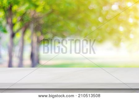 Empty white marble table over blur green park nature background product display montage