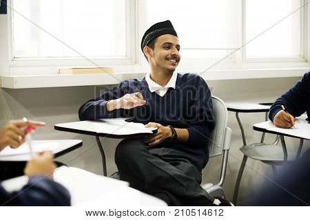 diverse muslim children studying in classroom