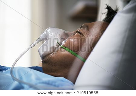 A sick Asian man in a hospital