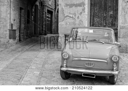 SPELLO, ITALY - MAY 27 2017 - An italian vintage car parked in a street of the historical center of Spello in Umbria
