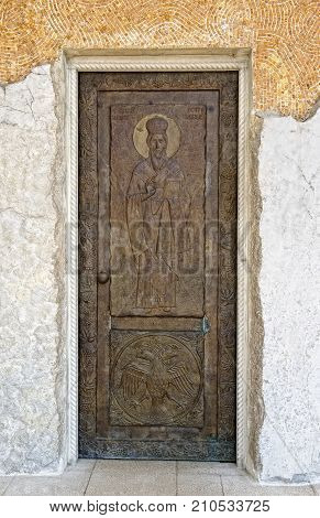 MONTENEGRO, PODGORICA - AUGUST 10, 2017: elements of decor and architecture of the Cathedral of the Resurrection of Christ a door with the image of St. Basil Ostrogsky