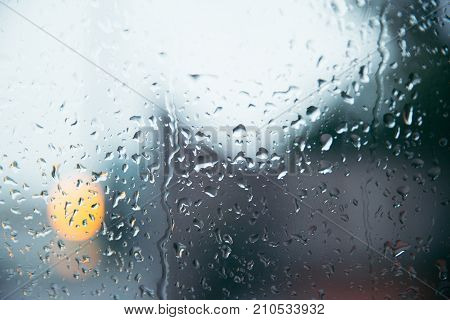 drops on the window with the background of the city lights