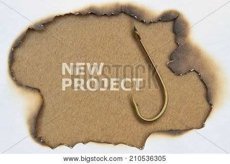Text New Project written on paper and a fishing hook