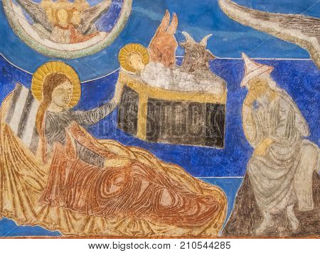 The holy family in the stable with Mary Joseph and the child a medieval wall-painting in Bjaresjo church Sweden November 6 2009