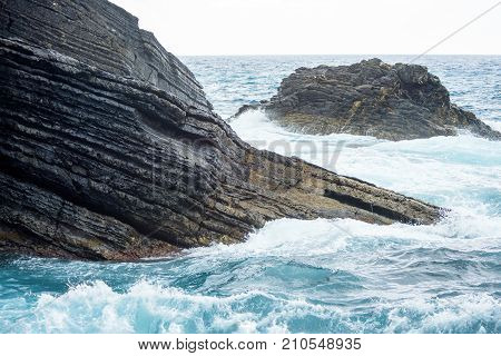 Water smashing big rocks in Vernazza, Cinque Terre, Italy