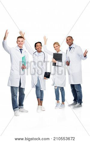 multiethnic cheerful female and male doctors isolated on white