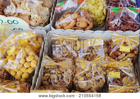 Variety of Malaysian traditional sweet food with a price tag on the street market of Oriental Village, Langkawi, Malaysia.
