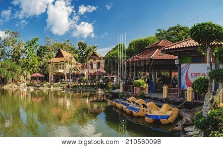 Langkawi, Malaysia - February 16, 2016: Oriental Village gateway to ride a cable-car up Mat Cingcang mountain. Luxury Paradise with pleasureboat on a lake, restaurants, hotels and shops for tourists