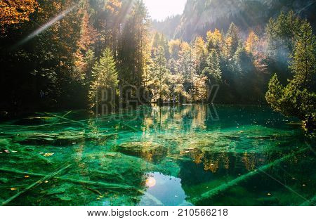 Autumn time at romantic forest lake Blausee, one of the best known mountain lakes in Switzerland.