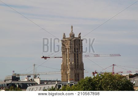 The tower Saint Jacques - Paris, France. The tower Saint Jacques is an isolated tower, built between 1509 and 1523, raised (drawn up) in the middle of the first Parisian public garden, which bears its name, in 4 District of Paris.