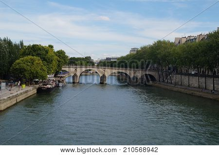 The Seine in Paris - France. The Seine in Paris is a part of the landscape of the capital of France. The Seine cuts Paris in its environment (middle) even if the right bank occupies a space more important than the left bank.