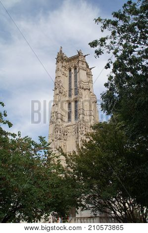 The tower Saint Jacques - Paris, France. The tower Saint Jacques is an isolated tower, built between 1509 and 1523, raised (drawn up) in the middle of the first Parisian public garden, which bears its name, in 4 District of Paris. 